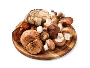 Wooden board with different fresh mushrooms on white background