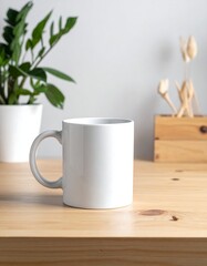 Plain white ceramic mug on a light wood surface, plant in background