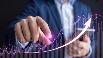 Business professional interacts with an upward trending financial graph overlaid on a dark background.