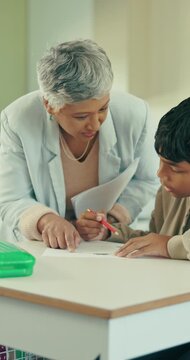 Teacher, help or child in classroom with paper, knowledge or question for assignment completion. Education, aid or student at table with enquiry, sld support or guidance for academic development.