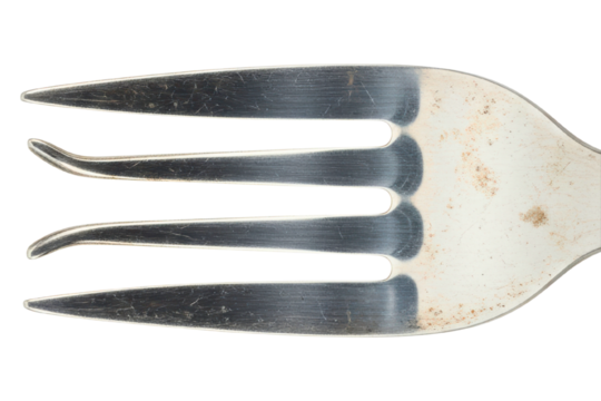 Macro shot of silver metal dining fork tines with scratches isolated on transparent background