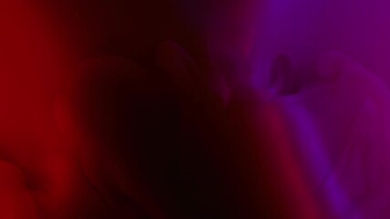 Mystic smoke. Ink vapor. Bright dye wave flow on purple red light water. Fantasy drop explosion abstract shade blur color background.