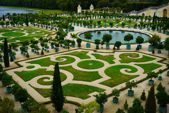 Gardens of Versailles with grand baroque landscaping, geometric parterres, ornate fountains, regal vistas, historic grandeur of the french royal palace