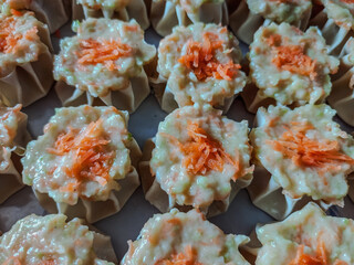 Fresh Dim Sum Filling with Wonton Wrappers and Carrot Topping