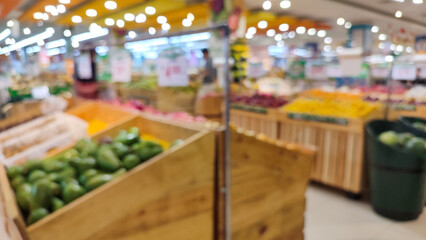 Blurred image of fruit displays in a supermarket, showcasing colorful produce arranged on shelves
