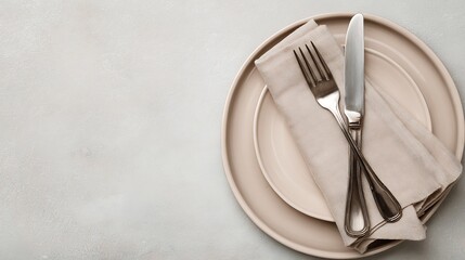 Elegant Table Setting with Beige Plates Silver Cutlery and Linen Napkin on Textured Gray Background Neutral Tones Top View