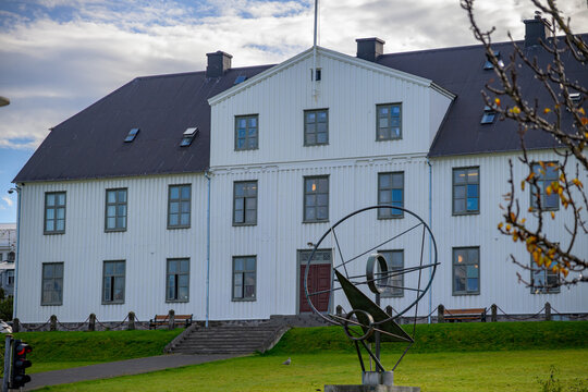 White historical building with black roof and modern sculpture in Reykjavik - Powered by Adobe