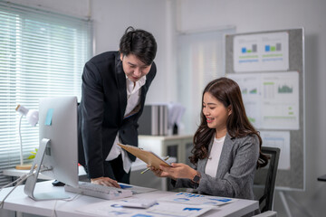 Asian businesspeople discussing and working together in modern office