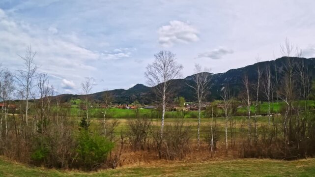 Tranquil extreme wide angle view through train window on the Innsbruck&ndash;Munich route capturing the shifting landscapes along the high-speed EuroCity and &Ouml;BB Railjet lines between Austria and Germany.