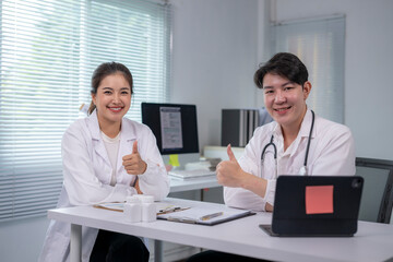 Doctors showing thumbs up approving successful medical treatment