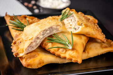Crispy fried chebureki with juicy meat filling
