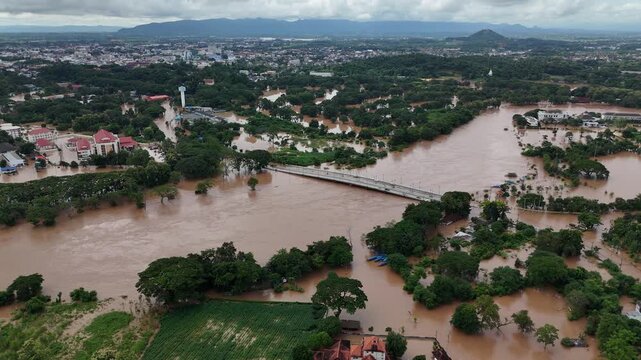 Aerial view of a bridge for crossing to downtown area in Chiang Rai province flooding by Kok river after typhoon Yagi has swept Southeast Asia.