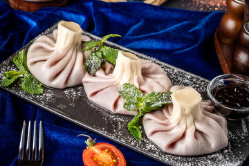 Sweet dessert khinkali with mint and chocolate sauce