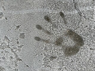 Handprint on gray concrete wall symbolizing curiosity in winter  