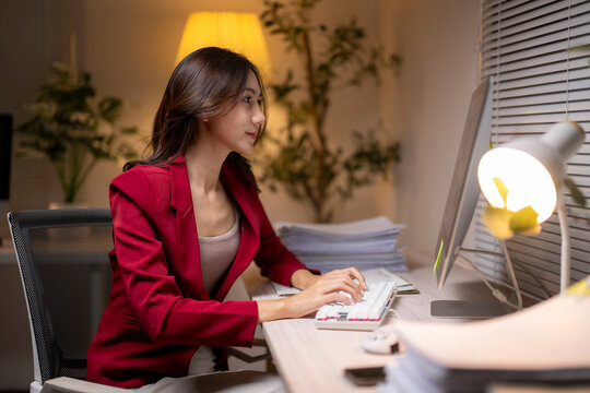 Woman working overtime late at night in office