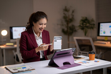 Businesswoman making video call explaining finance with calculator