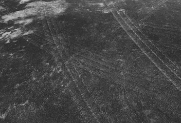 Close up black tire marks on cement floor.