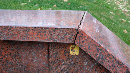 Granite bench with unique edges in a serene park setting