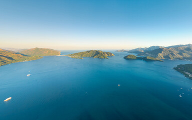 Marmaris, Turkey. Aerial view of Marmaris Bay with Cennet Island and Kechi Island with lighthouse. Two islands in the bay at sunset. Aerial view.