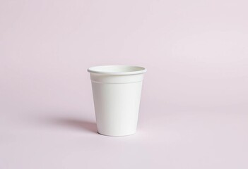 A pristine, disposable white paper cup sits on a plain background,  packaging,  hot beverage