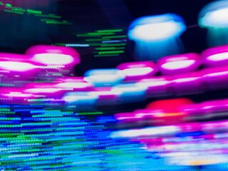 Neon light motion blur abstract background. Abstract blue, pink and green lights trail on the dark background