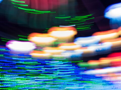 Neon light motion blur abstract background. Abstract blue, orange and green lights trail on the dark background - Powered by Adobe