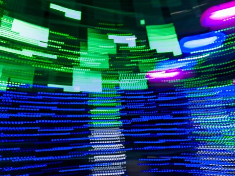 Neon light motion blur abstract background. Abstract blue, pink and green lights trail on the dark background