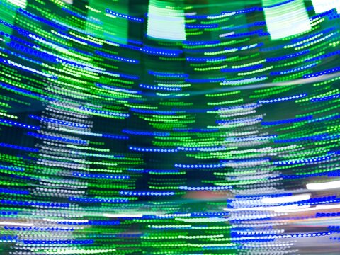 Neon light motion blur abstract background. Abstract blue, green and purple lights trail on the dark background