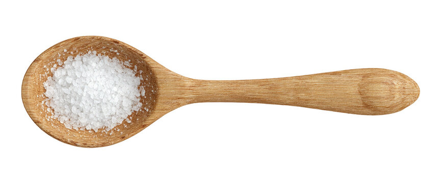 Wooden spoon holding coarse white salt crystals, isolated on black background