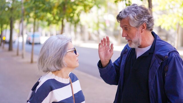 Mature senior couple arguing outdoors on the street - Powered by Adobe