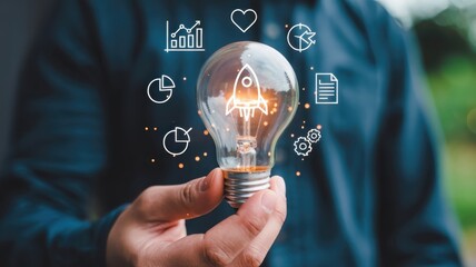 Person holds illuminated incandescent bulb symbolizing creative business concepts and growth