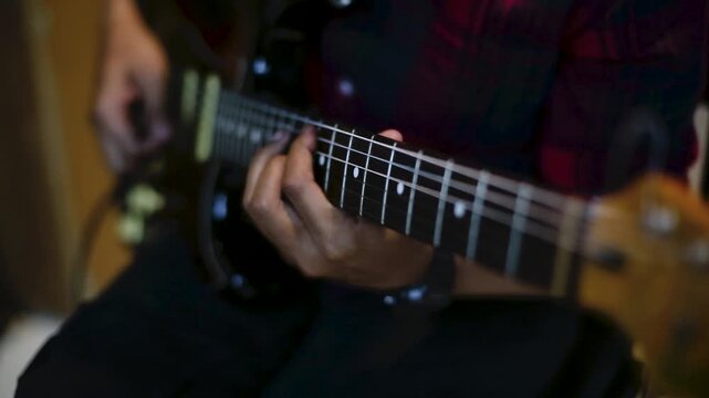 Close Up of Musician Playing Electric Guitar  in rehearsal studio details on fingerboard