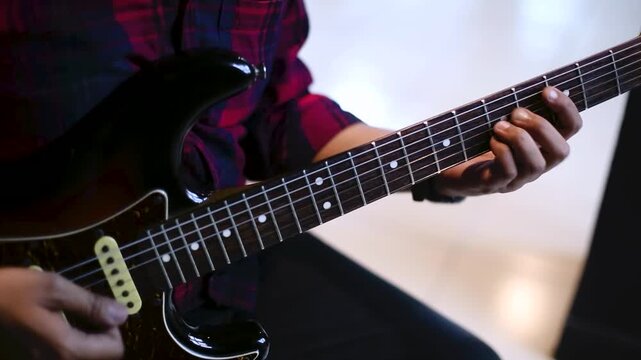 Close Up of Musician Playing Electric Guitar  in rehearsal studio  details on fingerboard