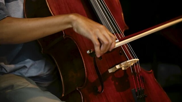 closeup details of Musician Playing Cello with Bow in rehearsal studio