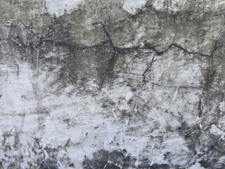 black cement wall with white paint with a few cracks background texture
