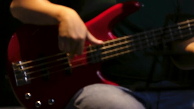Close up musician playing bass in reheasal studio