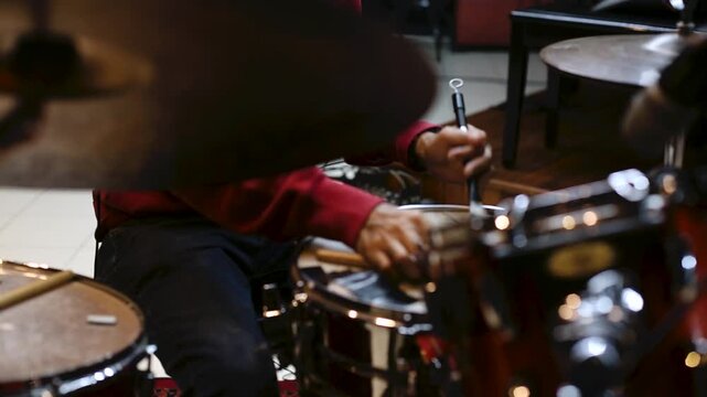 Man Playing Drum Set in Music Studio