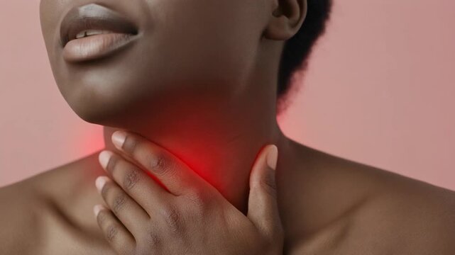African American woman suffering from a painful sore throat.