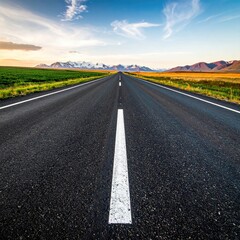 Fototapeta premium Road stretches to distant mountains under a bright sky