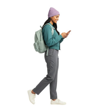 Stylish South Asian student texting on phone while walking forward, cutout isolated on transparent background