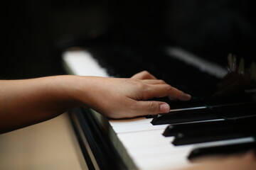 Fototapeta premium Hands Playing Piano Keys Close Up