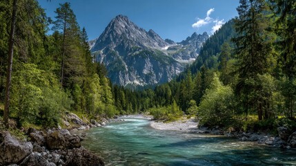 The crystal clear river flows gently through a vibrant green valley framed by towering mountains under a bright blue sky. Nature's beauty thrives in this peaceful landscape.