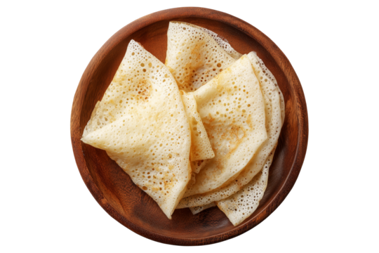 Rolled Brazil tapioca sweet crepe with airy texture on wooden plate, isolated on white transparent background, concept of traditional South American Cuisine