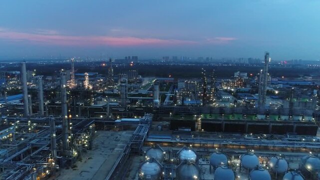 Industrial Manufacturing Plant with Storage Tanks at Dusk