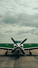 Propeller Plane on Tarmac Under Cloudy Sky