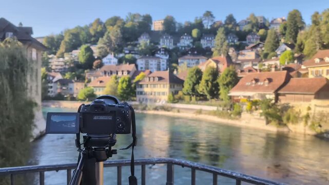Professional mirrorless video camera filming Aare river and old town Bern