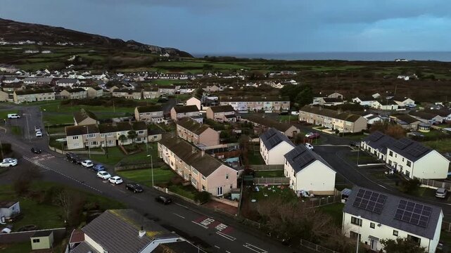Rainy Holyhead homes aerial view circling small island town neighbourhood mountain real estate
