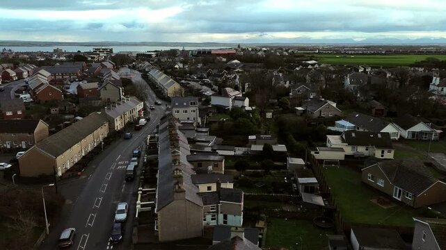 Rainy Holyhead homes aerial rising view above the small Welsh island town neighbourhood real estate