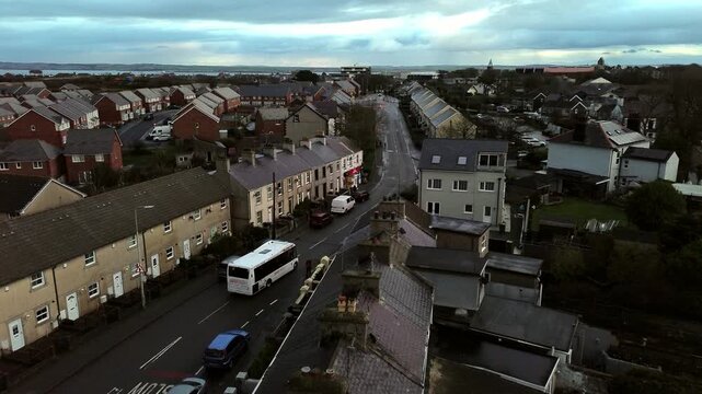 Rainy Holyhead homes aerial rising view circling small Welsh island town neighbourhood real estate