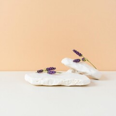 Two white aromatherapy sachets with lavender sprigs on a light surface